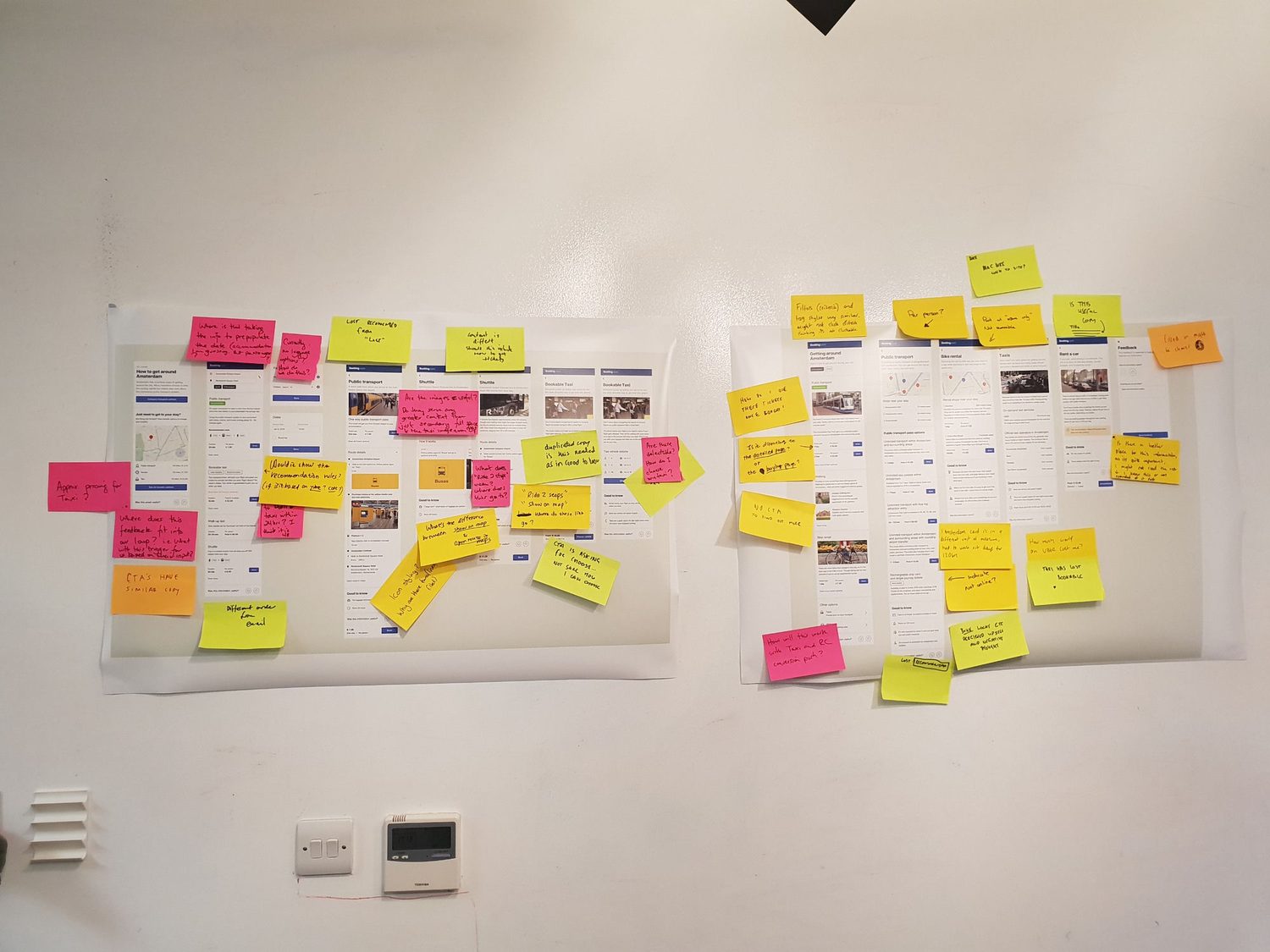 Journey-review wall with Booking.com screens covered in sticky-note questions
